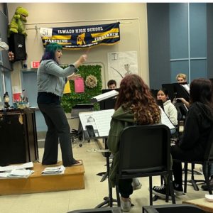 Music teacher Rachael Lake conducting a group of musicians at the Ilwaco High School.